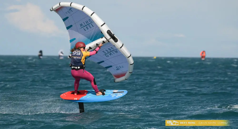 Starboards X-15 foilboard with blue deck and red fins for performance kiteboarding
