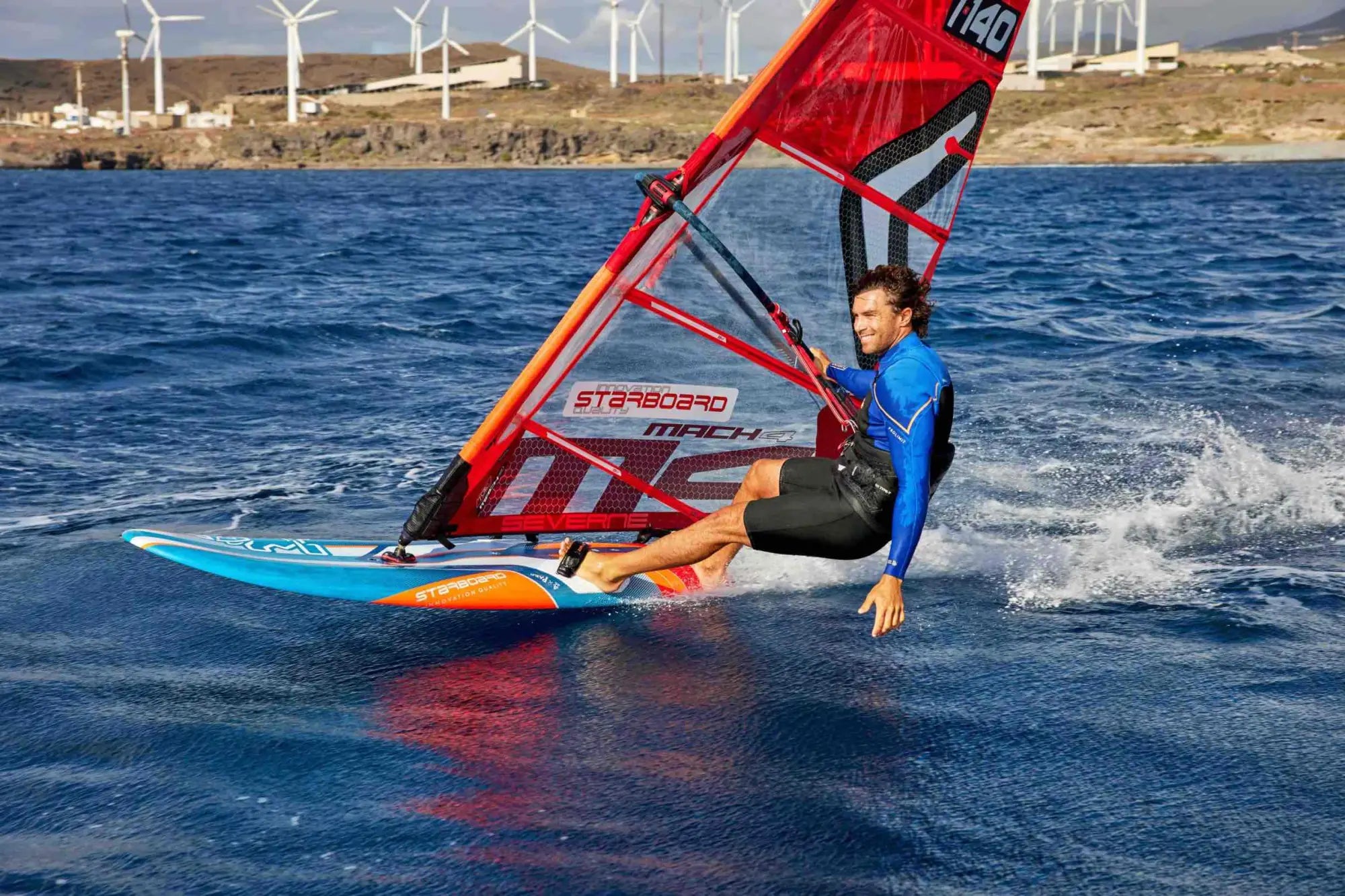 Red and black starboard windsurfing board with orange accents for performance