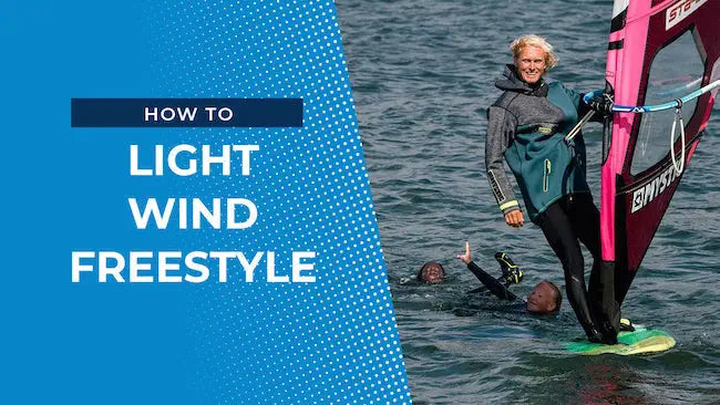 Pink windsurfing board with green fins and Swiss text on sail for light wind freestyle