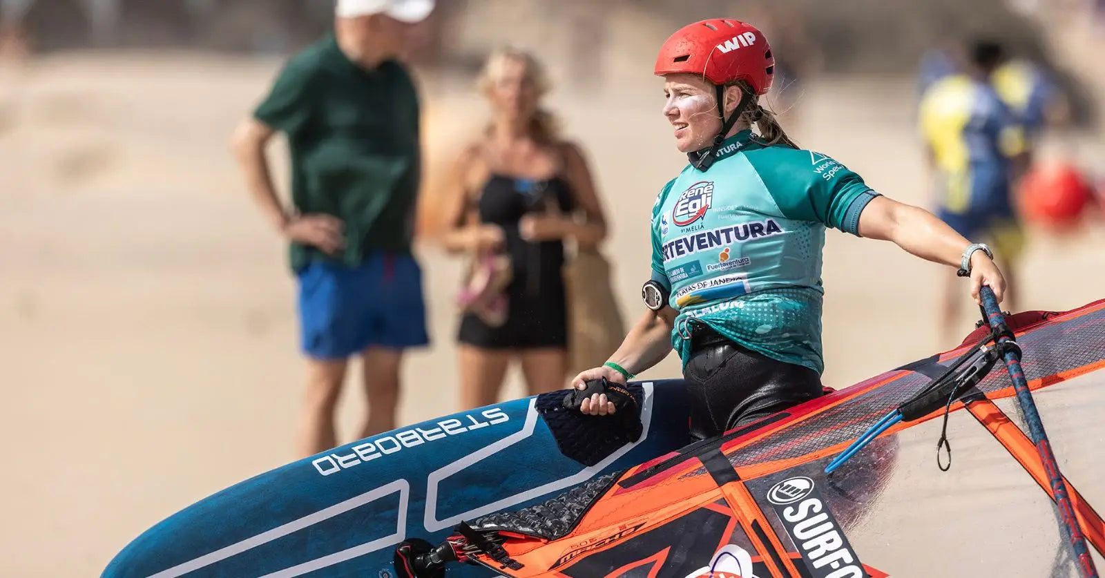 Vibrant orange teal Starboard windsurfing board with surf logo, Femke van der Veen