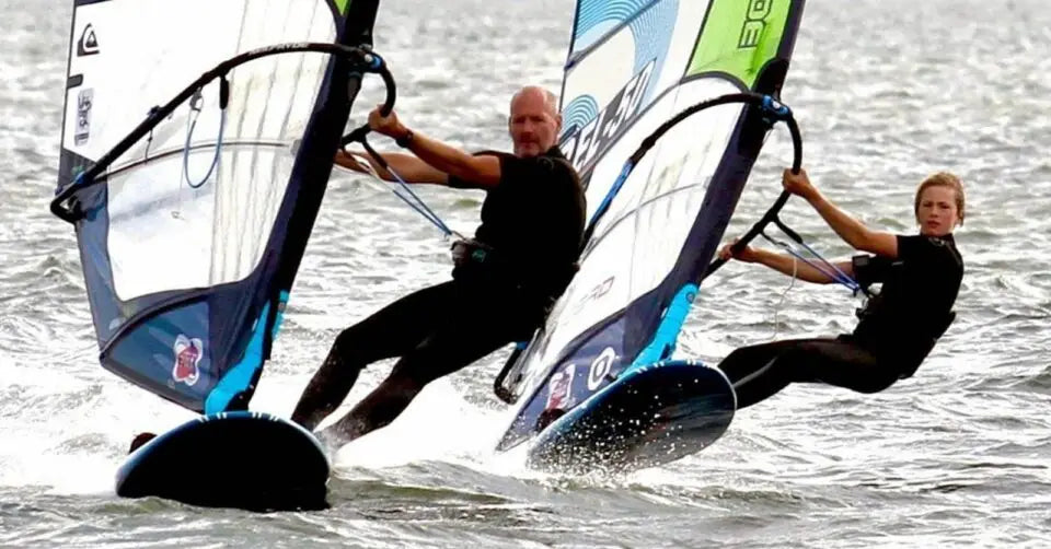 Ben windsurfing with son John John on blue and white board
