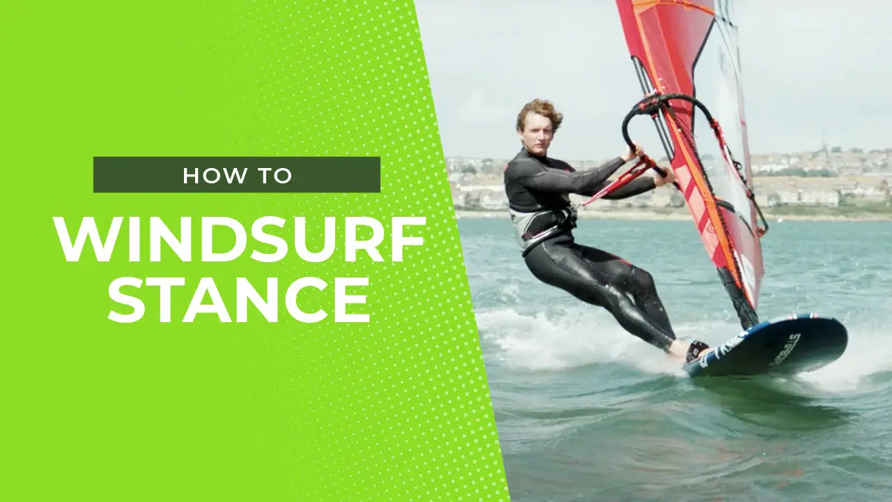 Stable red sail windsurfing board with black harness for water stability