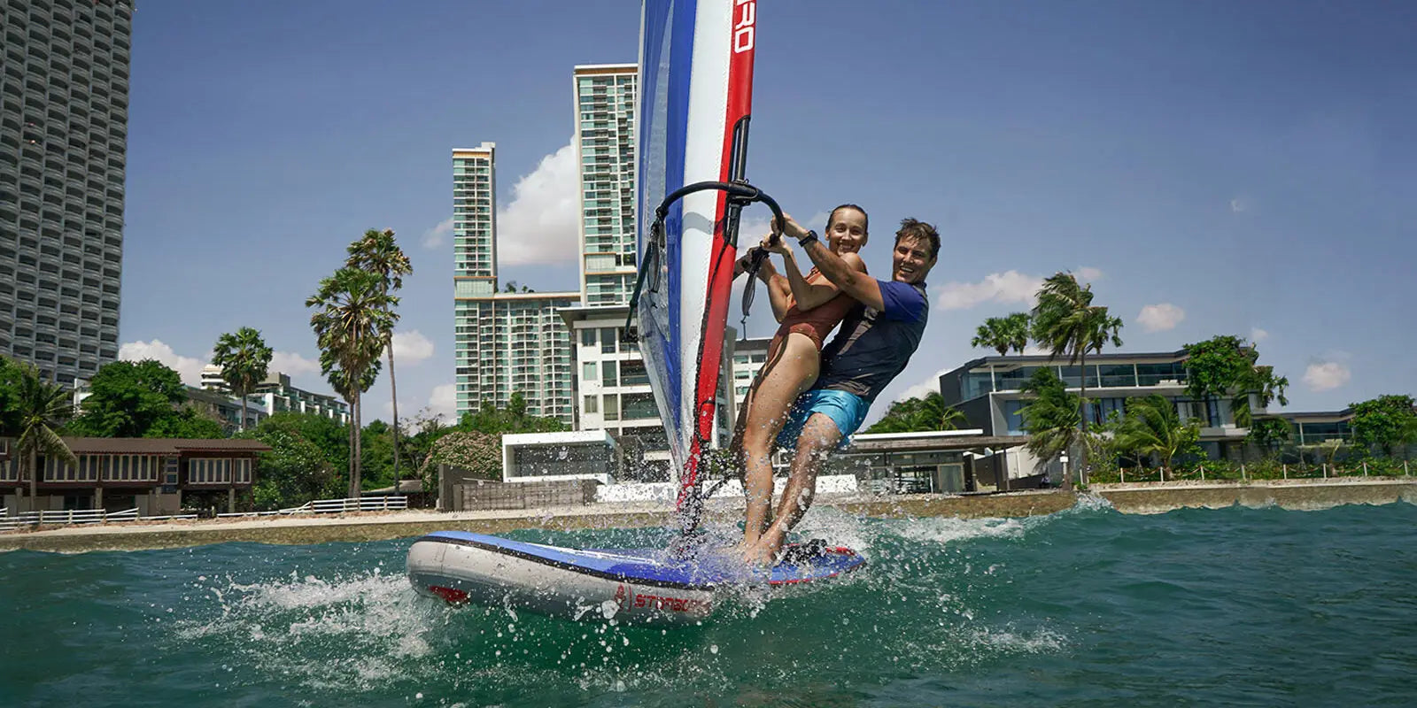 Red white SUP windsurf board with blue accents for water sports