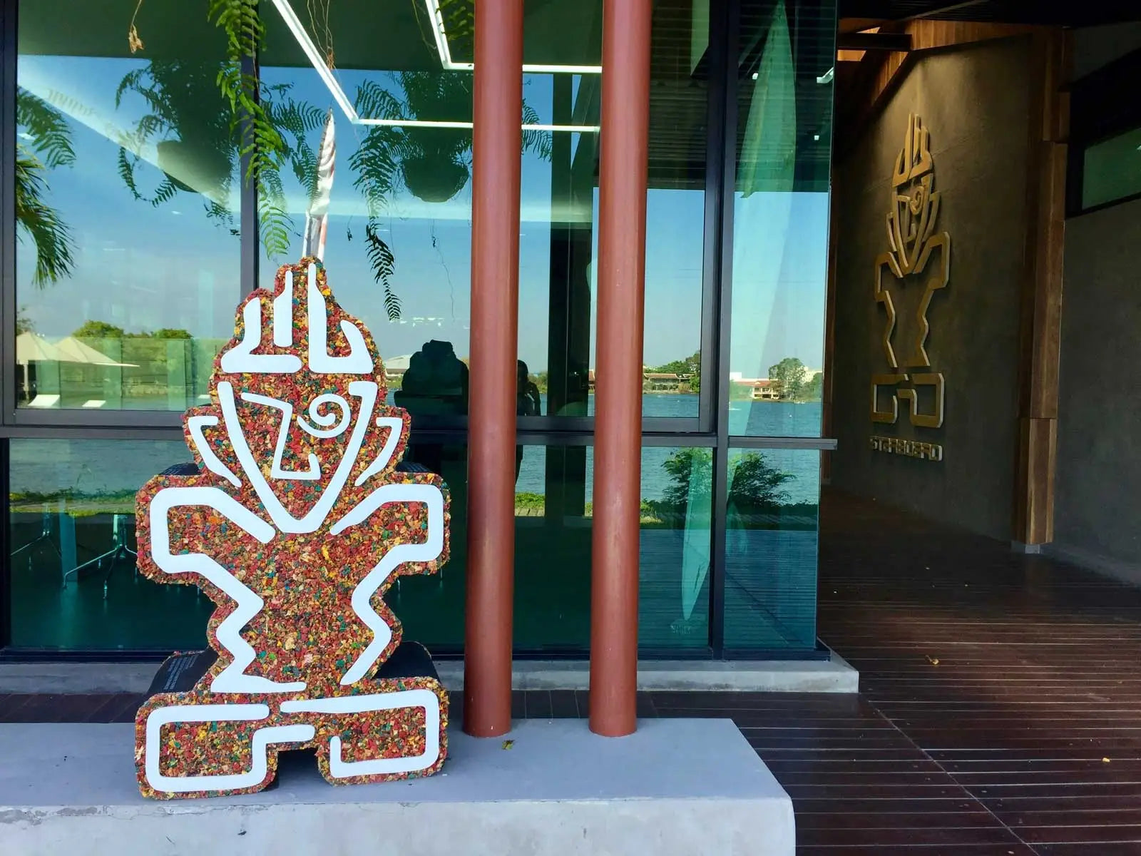Terracotta mosaic vase sculpture with white border in The Tiki Story