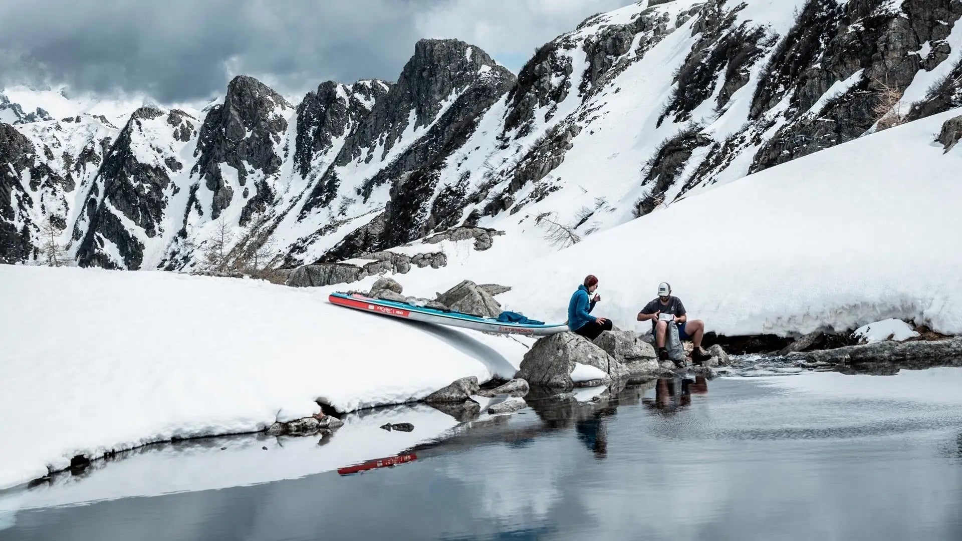 Blue and white striped tent with red accents in the Alps