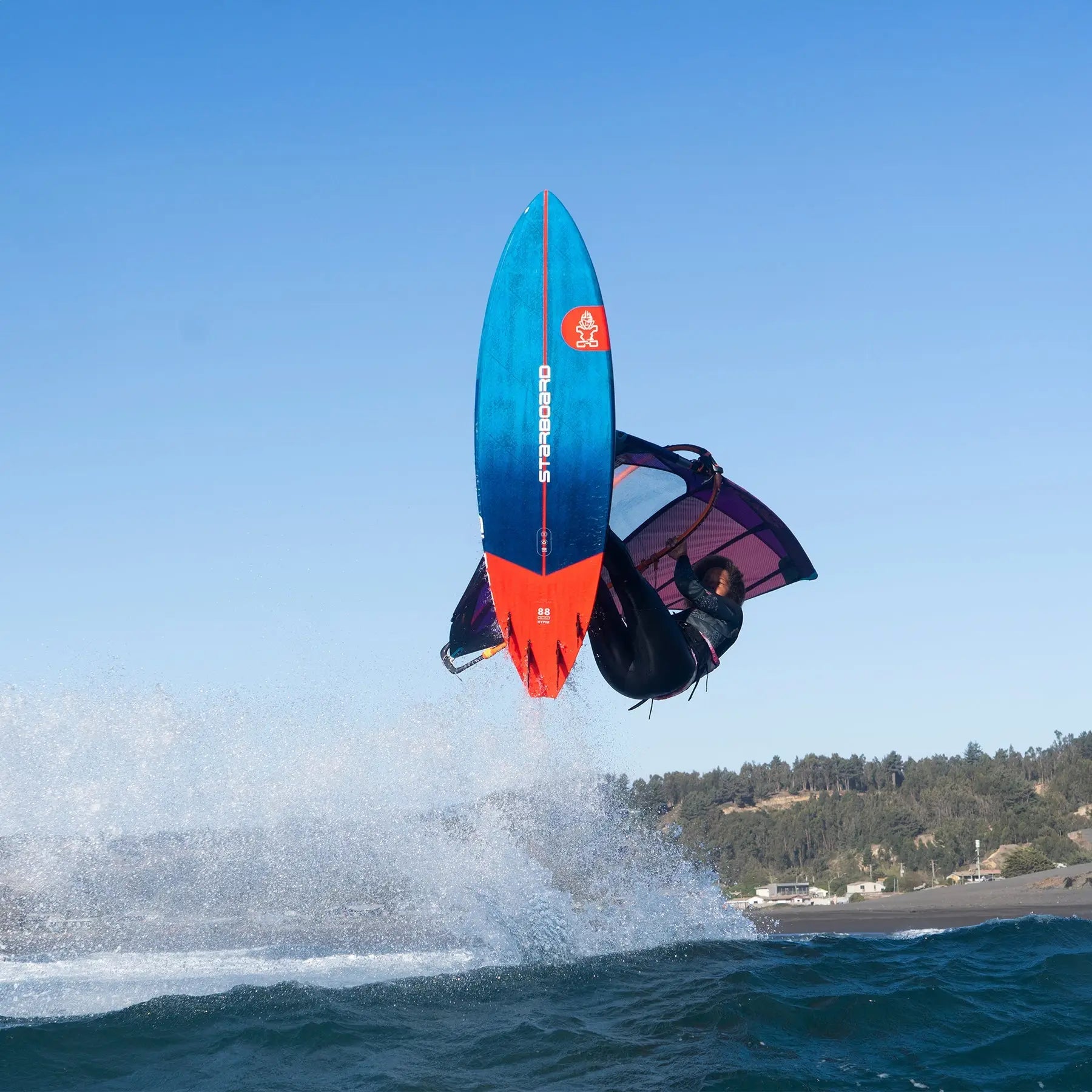 Blue and orange freestyle surfboard with red fins from 2025 Windsurf collection