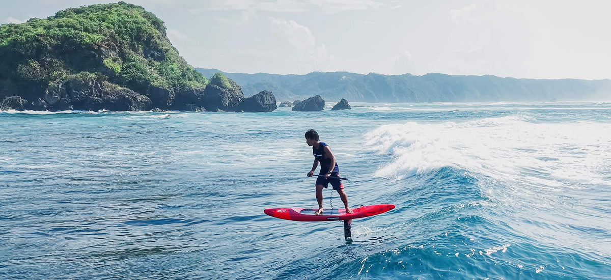 Sleek white and black hydrofoil surfboard with carbon fiber construction in Foilboards collection