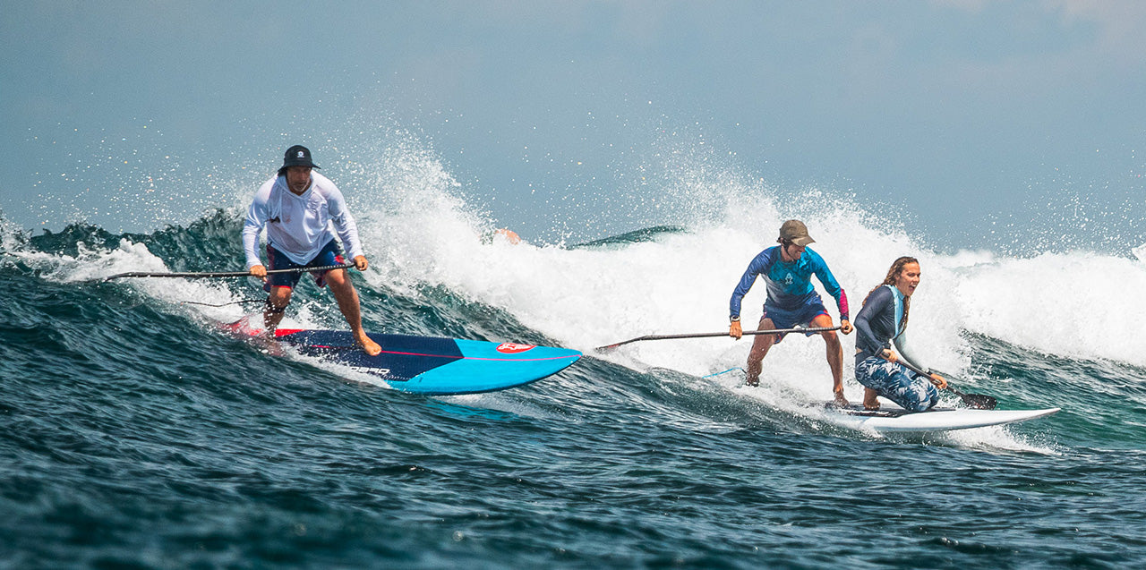 Blue and black all-round wave SUP paddleboard with red accents