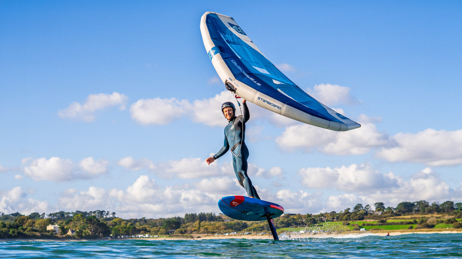 Blue kite with white accents and black lines for high performance kitesurfing in Wings collection