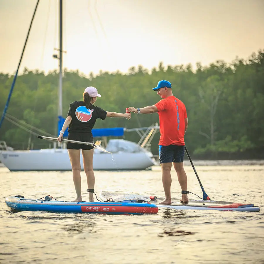 Blue and red SUP paddle board with white Sup text for stand-up paddling