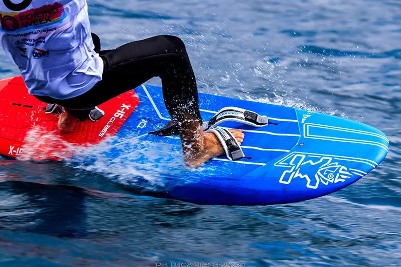 Blue and red polyurethane surfboard with white logo in Jim Drake Footstraps collection